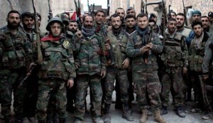 Syrian government forces pose for a photograph in the Karam al-Qasr district near the Neirab Airport of the northern city of Aleppo on January 26, 2014.