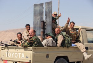 Iraqi Kurdish Peshmerga fighters celebrate sitting on the back of a truck as they head to the Mosul dam on the Tigris river that they recaptured from Islamic State jihadists on August 17, 2014 near the northern Iraqi city of Mosul. Peshmerga forces backed by US air strikes retook the country's largest dam, about 50 kilometres (30 miles) north of Mosul, that jihadist militants seized the previous week, officials said. AFP PHOTO/AHMAD AL-RUBAYE        (Photo credit should read AHMAD AL-RUBAYE/AFP/Getty Images)