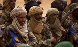 FILE - In this July 27, 2013 file photo, Malian Tuareg soldiers loyal to Col. Major El-Hadj Gamou listen during a visit by Mali's army chief of staff in Kidal, Mali. Tuareg separatist rebels agreed to sign a peace deal with the government in just over a weeks time but that hasnt stopped them from attacking towns and encroaching further south toward Malis capital. The toll has risen to 30 dead in recent days. (AP Photo/Rebecca Blackwell, File)