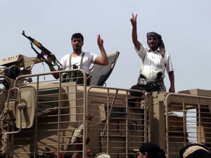 Southern militiamen loyal to Yemen's exiled President Abdo Rabbo Mansour Hadi flash victory signs following clashes with Houthi fighters in the southern port city of Aden, Yemen. EPA/STR