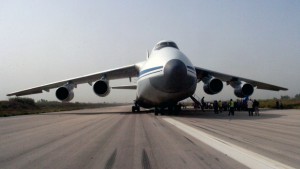 A handout picture released by the Syrian Arab News Agency (SANA) on September 12, 2015 shows a Russian plane carrying humanitarian aid being unloaded on the tarmac of the Martyr Bassil al-Assad international airport in the government-controlled coastal city of Latakia. Two Russian planes carrying 80 tonnes of humanitarian aid landed in Syria, state media said, amid reports that Moscow is beefing up military support to its ally Damascus. AFP PHOTO / HO / SANA RESTRICTED TO EDITORIAL USE - MANDATORY CREDIT "AFP PHOTO / HO / SANA" - NO MARKETING NO ADVERTISING CAMPAIGNS - DISTRIBUTED AS A SERVICE TO CLIENTS