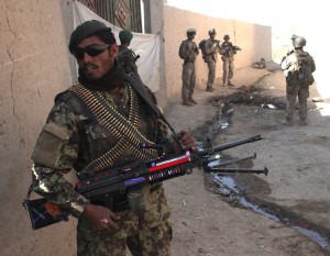 An Afghan National Army (ANA) soldier provides security during a foot patrol in Allikozai village, Sangin district, Helmand province, Afghanistan, Dec. 30, 2010. U.S. Marines with India Company, 3rd battalion, 5th Marine Regiment, 1st Marine Division patrolled the area with ANA soldiers to meet with village elders and deliver funds to help repair a mosque. (DoD photo by Gunnery Sgt. William Price, U.S. Marine Corps/Released)