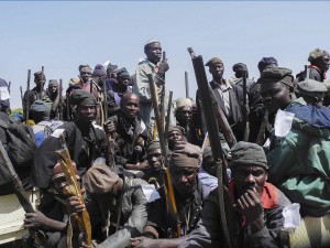 A group of Nigerian traditional hunters and vigilantes gather on vehicles on their way to engage Boko Haram militants in Mubi from Yola, Adamawa State, in November. The hunters have being assisting the Nigerian military in their fight against the Islamic insurgents.