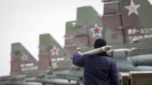 A serviceman carries a air-to-ground missile next to Sukhoi Su-25 jet fighters during a drill at the Russian southern Stavropol region, March 12, 2015.  Russia has started military exercises in the country's south, as well as in Georgia's breakaway regions of South Ossetia and Abkhazia and in Crimea, annexed from Ukraine last year, news agency RIA reported on Thursday, citing Russia's Defence Ministry.  REUTERS/Eduard Korniyenko  (RUSSIA - Tags: POLITICS CIVIL UNREST MILITARY)