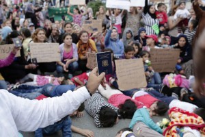 A man holds his Syrian passport as migrants and refugees protest against Turkish police blocking the access to the road and the ticket office for the Turkey-Greece border towns on September 15, 2015 at Istanbul's Esenler Bus Terminal. Over half a million migrants have crossed the European Union's border so far this year, up from 280,000 in 2014, the bloc's Frontex border agency said on September 15, 2015 -- but warned some people may have been counted twice. AFP PHOTO / YASIN AKGUL        (Photo credit should read YASIN AKGUL/AFP/Getty Images)