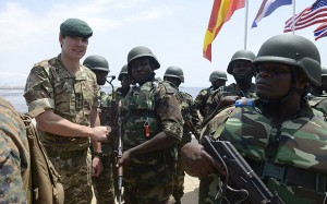 A British soldier (L) shakes hand with his Nigerian counterpart during a joint military exercise between Nigerian armed forces, United States, Britain, Netherlands and Spain in Lagos in October 18, 2013. Nigerian armed forces are participating in a three-week joint military training with special  forces specialising in fighting maritime criminals drawn from the United States, Netherlands, Britain and Spain, holding in southwest and southern coastal regions under the auspices of African Partnership Station (APS). The joint military exercise code named "African Winds" and spearheaded by the Nigerian Navy, is designed to improve the capacity of Nigeria's armed forces in its war against oil theft and other criminal activities in the creeks and high seas. AFP PHOTO/ PIUS UTOMI EKPEI        (Photo credit should read PIUS UTOMI EKPEI/AFP/Getty Images)