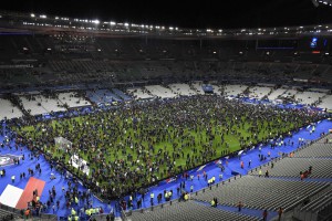 (FILES) This file photo taken on November 13, 2015 shows spectators gathering on the pitch of the Stade de France stadium following the friendly football match between France and Germany in Saint-Denis, north of Paris after a series of gun attacks occurred across Paris as well as explosions outside the national stadium where France was hosting Germany.  / AFP / FRANCK FIFE