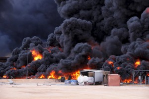 Smoke rises from burning oil storage tanks in the port of Ras Lanuf, Libya, January 23, 2016. - 23.01.2016 For commercial usage or advertising you have to contact ullstein bild prior to usage. | It is in the duty of the user of the image to clear prior to usage if any Third Party rights preclude the intended use. Released for Countries: Germany, Austria, Switzerland