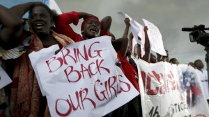 Women react during a protest demanding security forces to search harder for 200 schoolgirls abducted by Islamist militants two weeks ago, outside Nigeria's parliament in Abuja April 30, 2014. Scores of suspected Boko Haram gunmen stormed an all-girls secondary school in the village of Chibok, in Borno state, on April 14, packing the teenagers onto trucks and disappearing into a remote, hilly area along the Cameroon border. REUTERS/Afolabi Sotunde (NIGERIA - Tags: CIVIL UNREST RELIGION EDUCATION TPX IMAGES OF THE DAY) - RTR3NB21