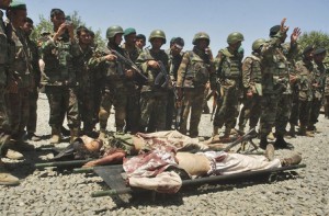 Afghan soldiers stand over the dead bodies of Taliban militants after they were killed in a failed ambush on Afghan forces in Qara Bagh district of Ghazni province, south west of Kabul, Afghanistan, on Tuesday, July 15, 2008.  (AP Photo/Rahmatullah Naikzad)