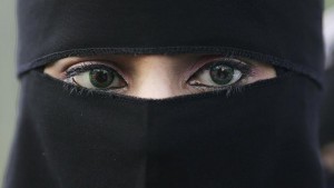 BLACKBURN, UNITED KINGDOM - OCTOBER 14:  A Muslim woman wearing a niqab veil protests outside Bangor Street Community centre where Leader of the House of Commons Jack Straw is holding one of his weekend surgery appointments where he faced a protest by around 50 Muslim protesters on October 14, 2006, Blackburn, England. Jack Straw made comments last week regarding his view that veils such as the Burqa and Niqab split communities. (Photo by Christopher Furlong/Getty Images)