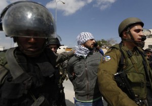 Israeli border policemen and soldiers detain a Palestinian protester during a protest against what Palestinians say is land confiscation by Israel for Jewish settlements, near the West Bank town of Abu Dis near Jerusalem March 17, 2015. REUTERS/Mohamad Torokman (WEST BANK - Tags: POLITICS CIVIL UNREST TPX IMAGES OF THE DAY) - RTR4TPCK