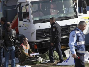 Israeli police investigates the scene of an attack in Jerusalem Sunday, Jan. 8, 2017. A Palestinian rammed his truck into a group of Israeli soldiers in Jerusalem on Sunday, killing four people and wounding 15 others, Israeli police and rescue services said, in one of the deadliest attacks of a more than yearlong campaign of violence. (AP Photo/Mahmoud Illean)