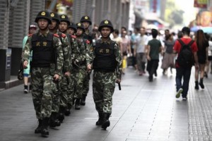 Paramilitary policemen patrol along a street in Shenzhen, Guangdong province, May 27, 2014.  REUTERS/Stringer